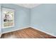 Bright bedroom with hardwood floors, a window offering natural light, and neutral colored walls at 4155 Guilford Nw Ct, Concord, NC 28027