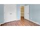 Bedroom with hardwood floors, a bright window, neutral colored walls, and a closet at 4155 Guilford Nw Ct, Concord, NC 28027
