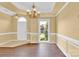 Dining room with wainscoting, chandelier, and a window view of the exterior at 4155 Guilford Nw Ct, Concord, NC 28027