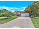 Brick home with a lush front lawn and a long driveway leading to an attached garage at 4155 Guilford Nw Ct, Concord, NC 28027