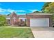 Charming brick home featuring a two-car garage and a well-maintained front yard at 4155 Guilford Nw Ct, Concord, NC 28027