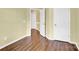 Hallway with neutral walls, hardwood floors, and multiple doors for easy access to other rooms at 4155 Guilford Nw Ct, Concord, NC 28027