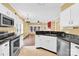 Well-lit kitchen features stainless steel appliances, granite countertops, and ample cabinet space at 4155 Guilford Nw Ct, Concord, NC 28027