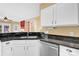 Bright kitchen with granite countertops, stainless steel dishwasher and white cabinets at 4155 Guilford Nw Ct, Concord, NC 28027