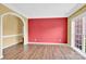 Living room with hardwood floors, an archway, and a bright window at 4155 Guilford Nw Ct, Concord, NC 28027