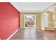 Living room with hardwood floors, an archway, and a bright window at 4155 Guilford Nw Ct, Concord, NC 28027