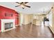 Open-concept living room with fireplace, modern ceiling fan, and laminate flooring at 4155 Guilford Nw Ct, Concord, NC 28027