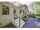 View of the backyard featuring a patio, white brick exterior, and lush landscaping at 4313 Sudbury Rd, Charlotte, NC 28205