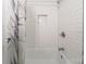 Tiled shower with built-in niche for toiletries and a stylish shower curtain at 4313 Sudbury Rd, Charlotte, NC 28205