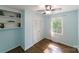 Bedroom featuring hardwood floors, closet with louvered doors, and a window at 4313 Sudbury Rd, Charlotte, NC 28205