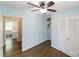 This bedroom features hardwood floors, a ceiling fan and louvered closet doors at 4313 Sudbury Rd, Charlotte, NC 28205
