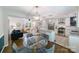 Open floor plan with eat-in kitchen, white cabinetry, stainless appliances, and a view to the living room at 4313 Sudbury Rd, Charlotte, NC 28205