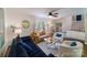 Bright living room featuring a ceiling fan, neutral paint, and a mix of comfortable seating options at 4313 Sudbury Rd, Charlotte, NC 28205