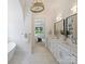 Elegant bathroom features double vanities, a soaking tub, and stylish fixtures at 5010 Ohm Ln, Charlotte, NC 28270
