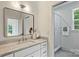Bright bathroom featuring marble countertop, modern vanity and glass-enclosed shower at 5010 Ohm Ln, Charlotte, NC 28270