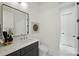 Contemporary bathroom with black vanity, quartz countertop, rectangular mirror and decor at 5010 Ohm Ln, Charlotte, NC 28270