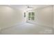 This bedroom features neutral carpeting and bright lighting from outside at 5010 Ohm Ln, Charlotte, NC 28270