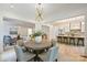 Open-concept dining area with views into the living room and kitchen, with hardwood floors throughout at 5010 Ohm Ln, Charlotte, NC 28270