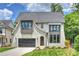Beautiful home featuring light brick, a dark gray roof, a two car garage, and a manicured front lawn at 5010 Ohm Ln, Charlotte, NC 28270
