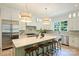 Well-lit kitchen featuring a marble island with seating, stainless steel appliances, and custom cabinetry at 5010 Ohm Ln, Charlotte, NC 28270