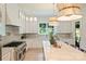 Modern kitchen featuring white cabinetry, stainless steel appliances, marble countertop, and a large island at 5010 Ohm Ln, Charlotte, NC 28270