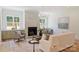 Bright living room features a marble fireplace, hardwood floors, and windows that let in lots of natural light at 5010 Ohm Ln, Charlotte, NC 28270