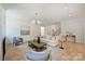 Open-concept living room boasts hardwood floors, modern lighting, and ample space for seating at 5010 Ohm Ln, Charlotte, NC 28270