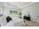 Main bedroom features tray ceilings, a large window with backyard views, and modern decor at 5010 Ohm Ln, Charlotte, NC 28270