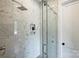 Modern shower featuring marble-look tile, a glass door and bench niche at 5010 Ohm Ln, Charlotte, NC 28270