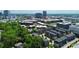 An aerial view of modern townhomes surrounded by trees and cityscape, highlighting community living and urban accessibility at 510 Music Hall Way, Charlotte, NC 28203