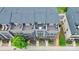 Aerial view of townhome community, showcasing rooftop patios, landscaping, and surrounding neighborhood at 510 Music Hall Way, Charlotte, NC 28203