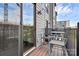 View of the wood floor on balcony with a metal table and two chairs at 510 Music Hall Way, Charlotte, NC 28203