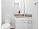 Bright bathroom with a granite vanity top, white cabinetry, and a large mirror at 510 Music Hall Way, Charlotte, NC 28203