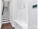 Entryway with dark wood floors, white walls, coat rack, and stairs leading to the upper level at 510 Music Hall Way, Charlotte, NC 28203