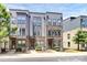 Contemporary townhome showcasing a brick and gray facade, multiple windows, and manicured landscaping in a well-maintained community at 510 Music Hall Way, Charlotte, NC 28203