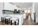 Bright kitchen featuring white cabinetry, stainless steel appliances, granite counters, and a gray tile backsplash at 510 Music Hall Way, Charlotte, NC 28203