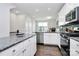 Modern kitchen featuring white cabinets, stainless steel appliances, and an island with granite countertops at 510 Music Hall Way, Charlotte, NC 28203