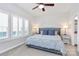 Bright main bedroom features neutral walls, plush carpet, ceiling fan, and large window with white shutters at 510 Music Hall Way, Charlotte, NC 28203