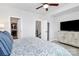 Bright bedroom boasts a ceiling fan, television, walk-in closet, and neutral colored walls and carpet at 510 Music Hall Way, Charlotte, NC 28203