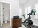 This office features a Peloton stationary bike, a sleek desk, and an adjacent bathroom at 510 Music Hall Way, Charlotte, NC 28203