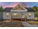 Charming home showcasing a welcoming entrance, a covered porch, and tasteful landscaping at 522 Waco Rd, Kings Mountain, NC 28086