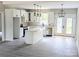 Bright kitchen with white cabinets, island, stainless appliances, and wood floors at 524 Waco Rd, Kings Mountain, NC 28086