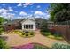 Backyard view showing a manicured garden area and gravel pathway leading to the home at 5404 Dunedin Ln, Charlotte, NC 28270
