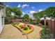 Backyard showing a garden area with manicured hedges, gravel pathway and flowerbeds at 5404 Dunedin Ln, Charlotte, NC 28270