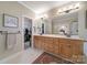 Bathroom offers a double vanity, large mirror and is adjacent to a walk-in closet at 5404 Dunedin Ln, Charlotte, NC 28270