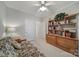 Bedroom featuring a ceiling fan, built-in wooden shelves, and soft carpeting at 5404 Dunedin Ln, Charlotte, NC 28270