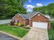 Lovely brick home with a well-kept yard and an attached two-car garage at 5404 Dunedin Ln, Charlotte, NC 28270