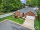 Beautiful brick home with attached garage and a lush green lawn and landscaping at 5404 Dunedin Ln, Charlotte, NC 28270