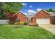 Charming brick home featuring a manicured lawn and a bright red front door at 5404 Dunedin Ln, Charlotte, NC 28270