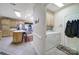 The kitchen area features an adjacent laundry room, located off of a hallway at 5404 Dunedin Ln, Charlotte, NC 28270